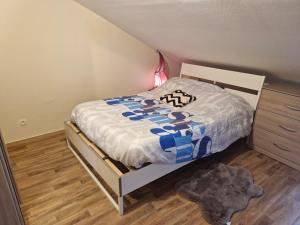 a small bedroom with a bed and a dresser at Carthage in Vierzon