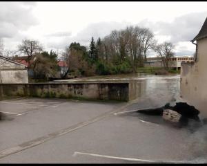 a flooded parking lot with smoke coming out of it at Carthage in Vierzon