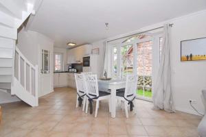 a kitchen and dining room with a table and chairs at Gartenweg 3d in Tinnum