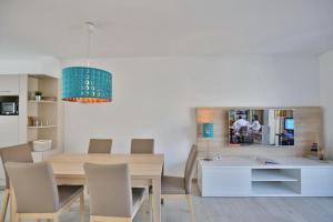 a kitchen and dining room with a table and chairs at City Marina, CM24b in Cuxhaven