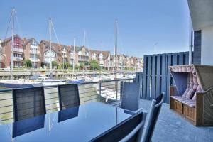 a balcony with a glass table and a marina at City Marina, CM24b in Cuxhaven