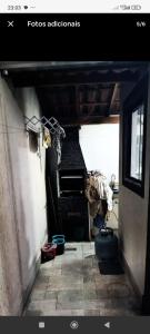 a view of a room with a piano in a room at Casa de Praia Beta Simão in Praia Grande