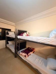 two bunk beds are in a room with at Aya House in Casablanca