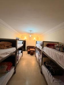 a room with several bunk beds in a room at Aya House in Casablanca