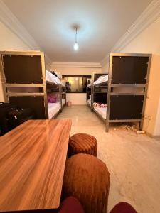 a room with three bunk beds and a table and chairs at Aya House in Casablanca