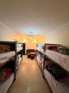 a room with several bunk beds in a room at Aya House in Casablanca