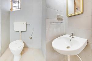 a white bathroom with a toilet and a sink at Collection O Electronic City in Bangalore