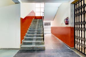 a staircase in a building with red and white walls at Collection O Electronic City in Bangalore
