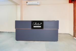 a blue refrigerator in a room with a sign on it at Collection O Electronic City in Bangalore