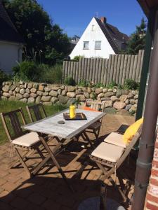 a picnic table and chairs on a patio at Haus Clara in Hörnum