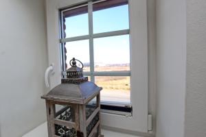 a small lantern in front of a window at Haus Clara in Hörnum
