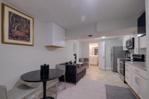 a kitchen and a living room with a table at Work & Explore, Cozy Unit 5 Mi to UMD! in Lanham +16 photos