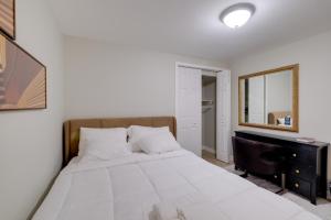 a bedroom with a large bed and a mirror at Work & Explore, Cozy Unit 5 Mi to UMD! in Lanham