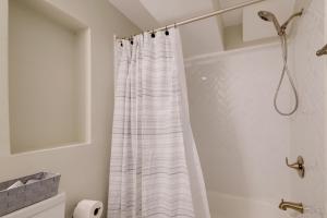 a white shower curtain in a bathroom with a tub at Work & Explore, Cozy Unit 5 Mi to UMD! in Lanham