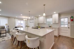 a kitchen with a large island and white cabinets at Great for Gatherings! Modern Lanham Duplex in Lanham