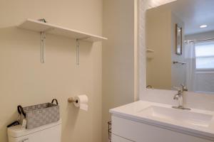 a white bathroom with a sink and a mirror at Great for Gatherings! Modern Lanham Duplex in Lanham +25 photos