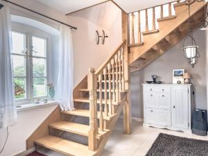 una scala in legno in una casa con finestra di De Utkieker a Witzwort Altre 10 foto
