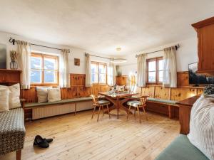 a room with a table and chairs and a bed at Tirola Hütte in Alpbach