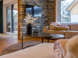 a living room with a vase of flowers on a table at Mountain Chalet Luxx in Sankt Lorenzen ob Murau