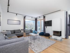 een woonkamer met een bank en een open haard bij Doppellodge in Sankt Lorenzen ob Murau