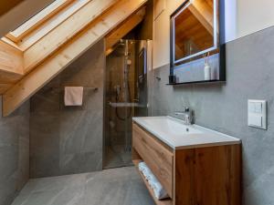 a bathroom with a sink and a shower at Mountain Chalet Luxx in Sankt Lorenzen ob Murau +61 photos