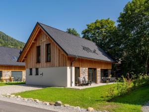 a barn style house with a gambrel roof at Mountain Chalet Dahoam in Sankt Lorenzen ob Murau