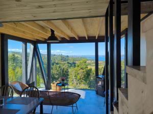 a view from the living room of a house with a view at Casa Esquila de Chiloé in Chonchi