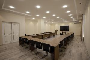 a conference room with a long table and chairs at Marmar Family Restaurant and Hotel in Nukus