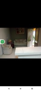 a living room with a couch and a table at quarto colhao casal no chao in Chapada dos Guimarães