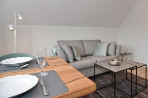 a living room with a couch and a table at Luv & Lee, Whg 11a in Westerland