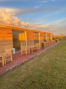 rząd ławek na ganku domu w obiekcie bourrous luxury camp w mieście Oulad Boudene