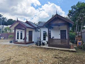 a small white house with a roof at Rumah Comel Temerloh Studio in Temerloh