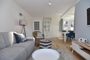 a living room with a couch and a table at Luv & Lee, Whg 10 in Westerland