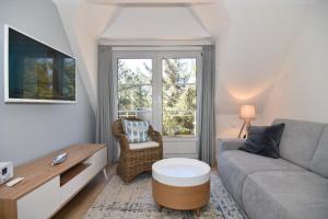 a living room with a couch and a table at Luv & Lee, Whg 10 in Westerland