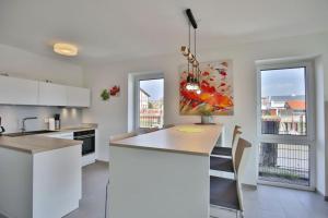 a kitchen with white cabinets and a kitchen island at City Marina, CM16c in Cuxhaven