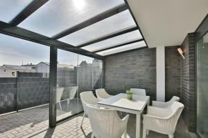 a patio with a white table and chairs on a balcony at City Marina, CM16c in Cuxhaven