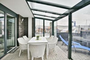 a patio with a white table and chairs on a balcony at City Marina, CM16c in Cuxhaven