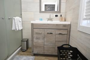 a bathroom with a sink and a mirror at Sunsetville in Savannah Sound +30 photos