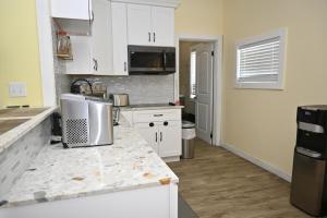 a kitchen with white cabinets and a counter top at Sunsetville in Savannah Sound