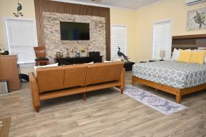 a bedroom with a bed and a tv on a brick wall at Sunsetville in Savannah Sound
