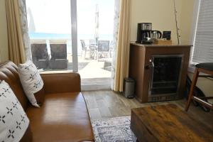 a living room with a couch and a fireplace at Sunsetville in Savannah Sound