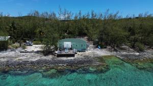an aerial view of a house and the water at Sunsetville in Savannah Sound