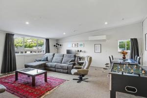 een woonkamer met een bank en een tafel met een schaakbord bij The Upper Rooms in Nelson