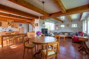 a kitchen and living room with a table and chairs at Mawe Huus in Oldsum