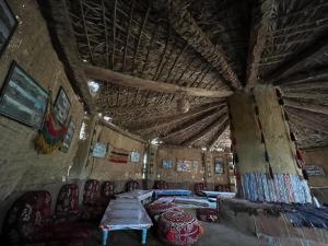 a room with tables and chairs in a building with a ceiling at The Garden Under The Moon in Al Ḩayz +48 photos