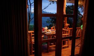 a view of a table from a window of a porch at Eco Cabins Hideaway Ella in Ella +45 photos