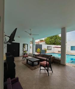 a living room with a couch and chairs and a pool at Oasis de Ricaurte in Ricaurte