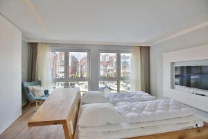 a bedroom with two beds and a large window at City Marina, CM22a in Cuxhaven