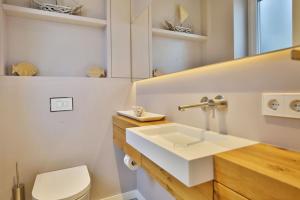 a bathroom with a white sink and a toilet at City Marina, CM22a in Cuxhaven +15 photos