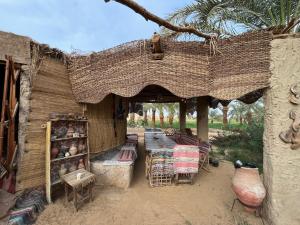 an outside area of a building with a table and chairs at The Garden Under The Moon in Al Ḩayz